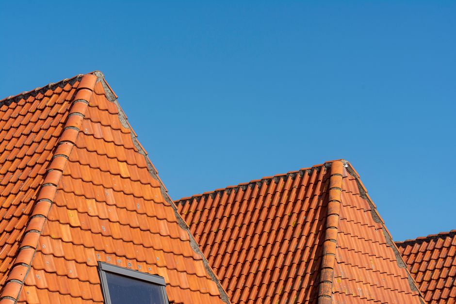 Toits en tuiles rouges sous un ciel bleu